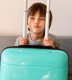 Kid's camp in England UK. How will the child fly alone?